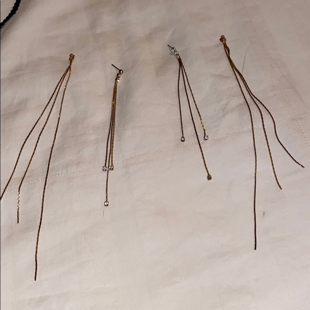 Gold long earrings with diamonds.